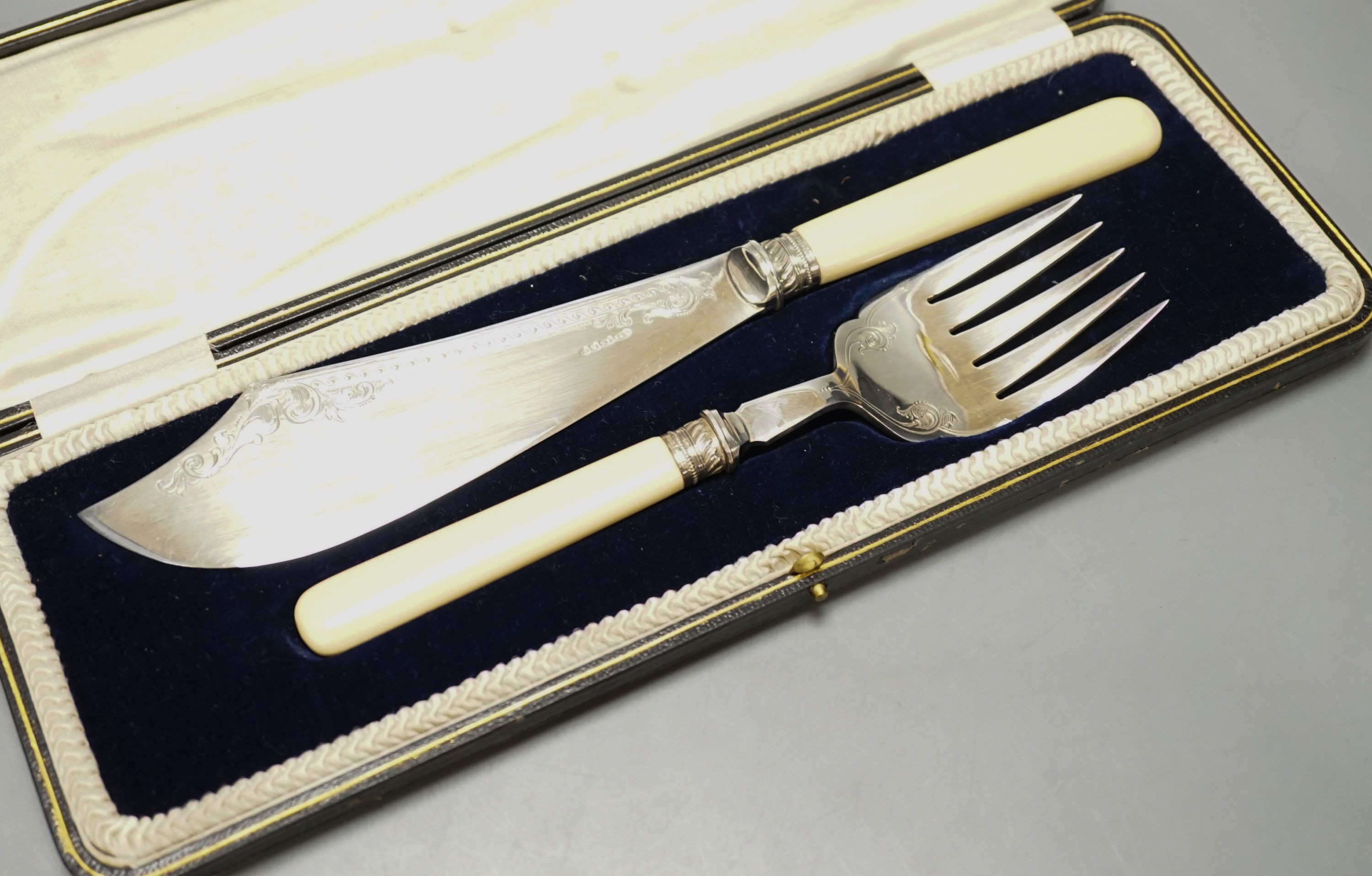 A cased pair of ivory handled silver plated fish servers.